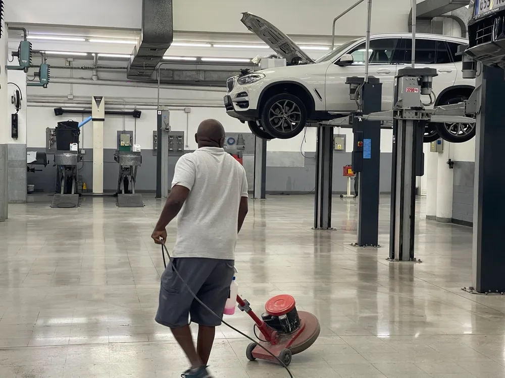 Empleado de Servicios24 con la pulidora en el taller del concesionario BMW de Lleida
